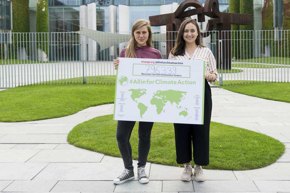 Rebecca Freitag und Pia Jorks mit dem internationalen Kampagnenschild. Foto: Change.org
