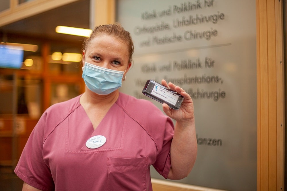 Schwester Elke Berenß von der Chirurgischen Ambulanz mit einem der neuen Pager, der es Patienten möglich macht, sich vom eigentlichen Wartebereich zu entfernen. Foto: Hagen Deichsel / UKL
