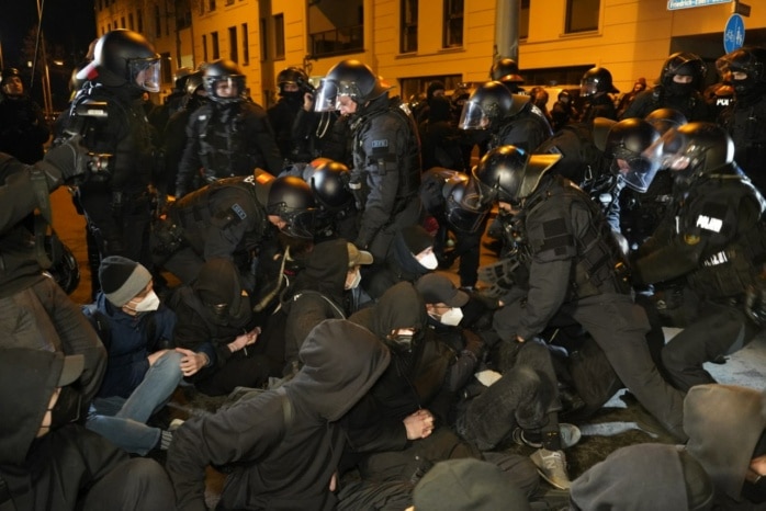 Die Polizei räumt eine Straßenblockade mit körperlichem Zwang und Schmerzgriffen