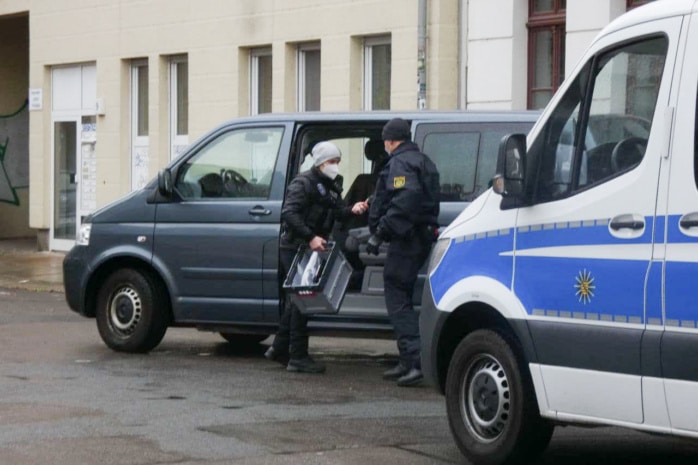 Polizisten an einem zivilen Fahrzeug.