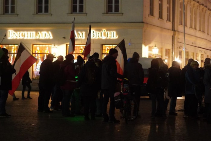 Mehrere Menschen auf einer Kundgebung am Abend auf dem Leipziger Richard-Wagner-Platz