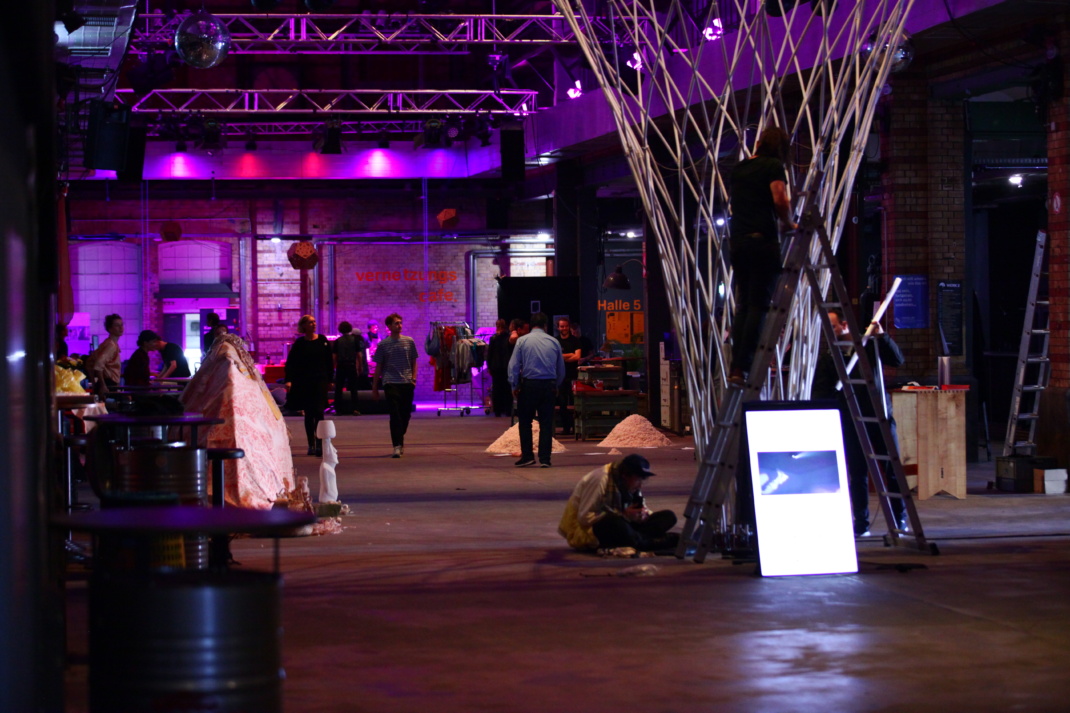 Eine Halle, mehrere Personen darin, Videoinstallation