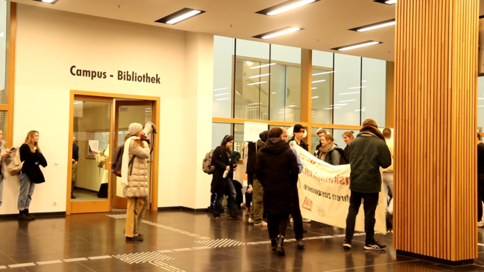 Aktive von #WirFahrenZusammen intervenieren im Hörsaalgebäude und rufen zum Soli-Foto auf. Foto: Katharina Subat / LZ TV