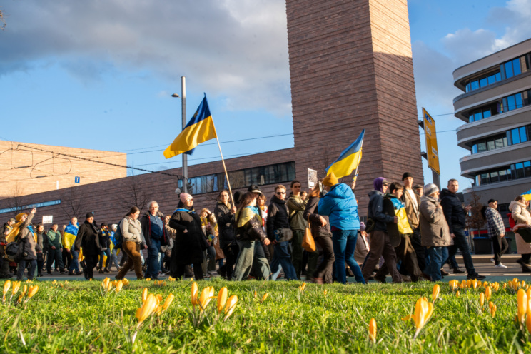 Menschen mit ukrainischen Flaggen marschieren in Leipzig.