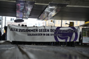 Protest mit Transparent unter einer Brücke.