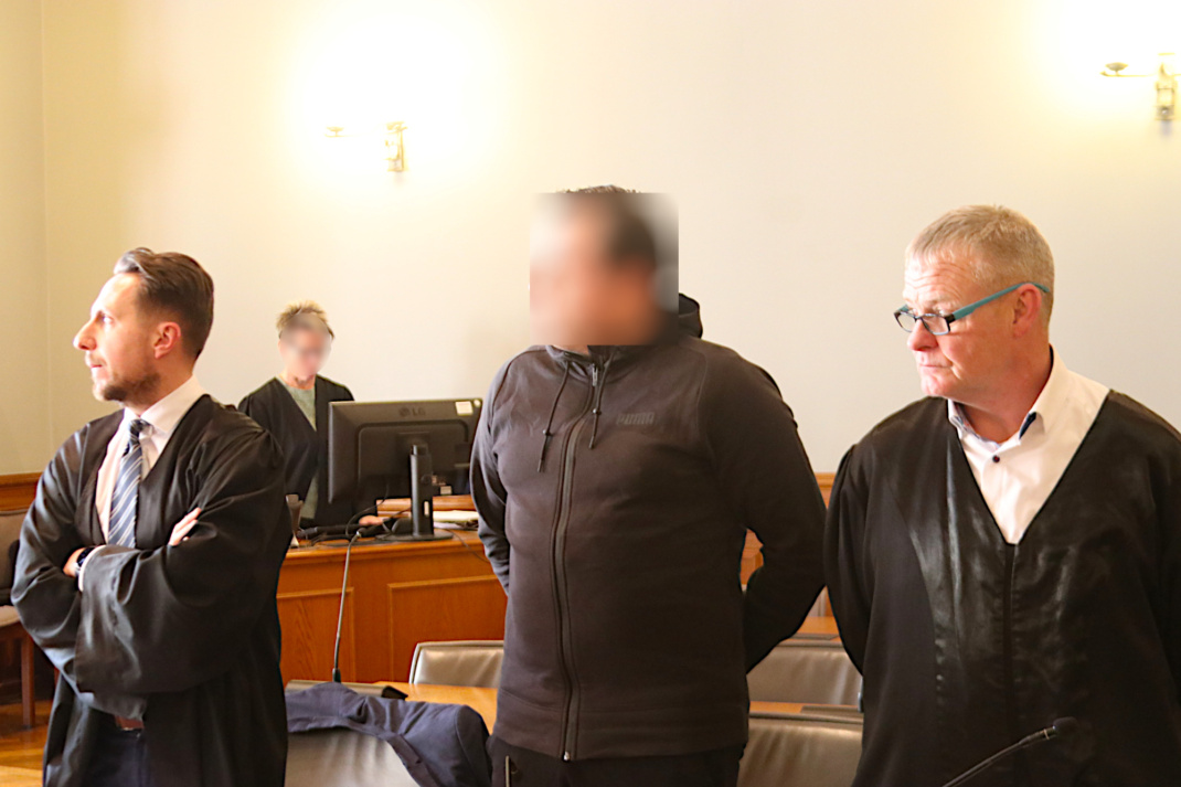 Angeklagter mit Anwälten vor Gericht.