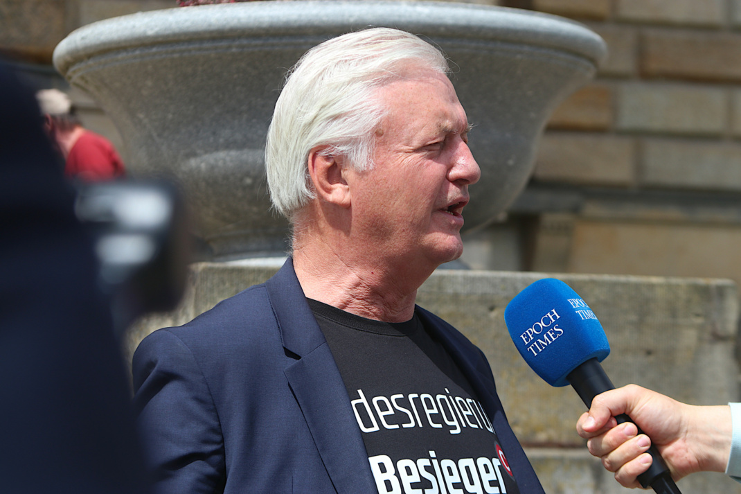 Jürgen Elsässer spricht in ein Mikrofon.