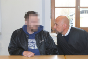 Angeklagrer sitzt neben seinem Anwalt.