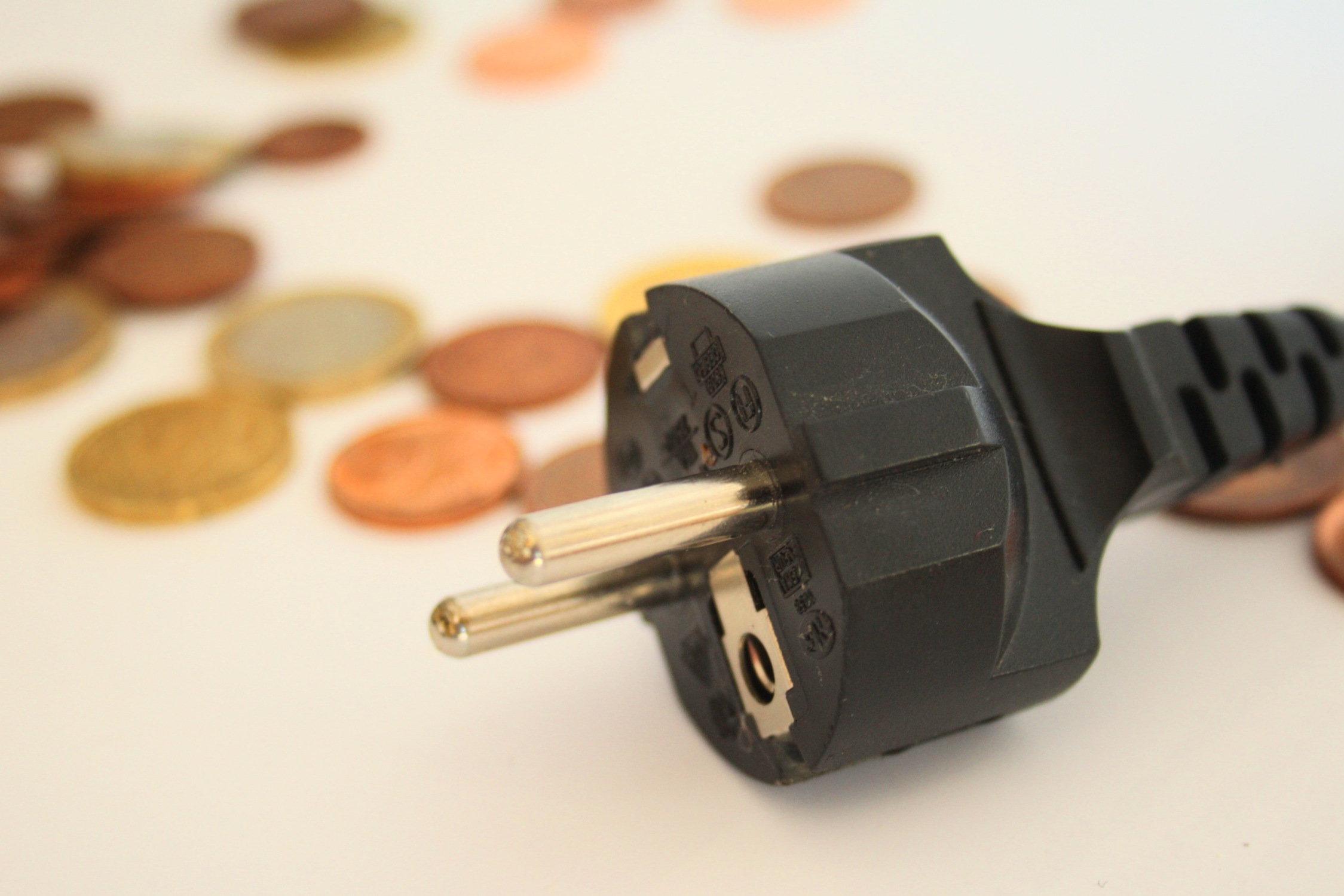 Münzen und Steckdosenanschluss.